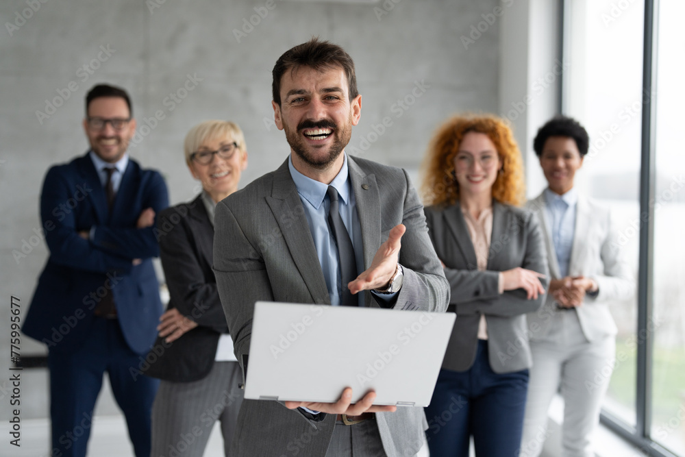 Group of business people standing and looking at camera at office Group of business people standing and looking at camera at office
