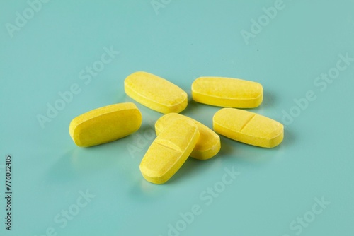 Closeup shot of a group of drugs in the form of yellow caplets photo