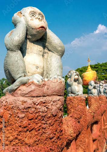 Sculptures of three monkeys sitting on orange columns with ‘see no evil, hear no evil, speak no evil’ theme.