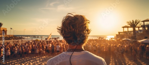 beach party DJ festival portrait with crowd of people in the background photo