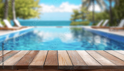empty wooden table top and blurred swimming pool in tropical resort with blurred background.
