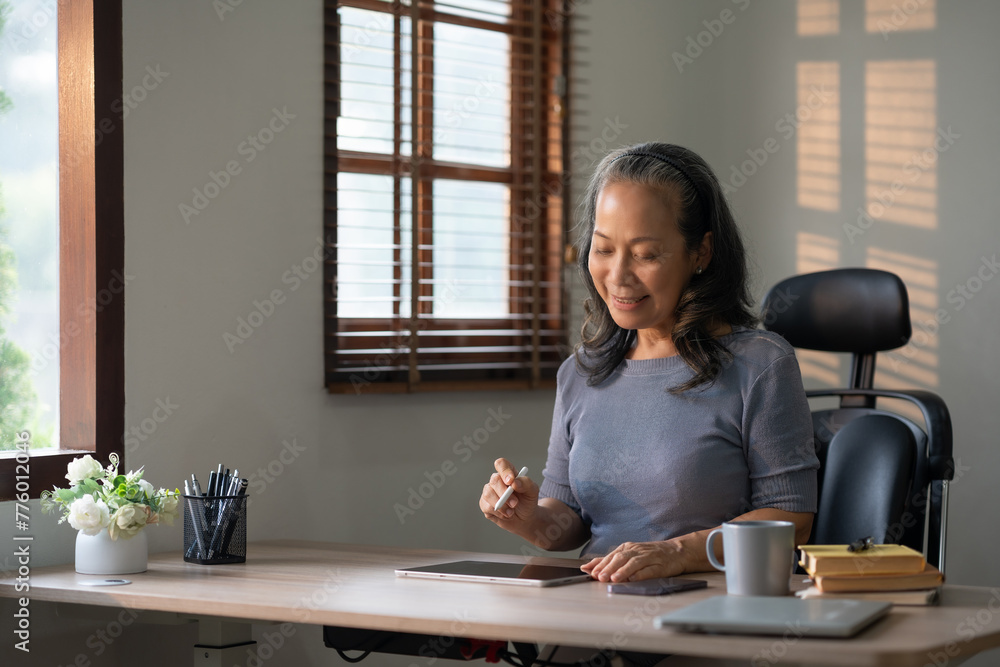 Senior Professional Working on a Digital Tablet Senior Professional Working on a Digital Tablet