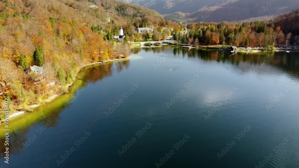 Aerial video of a bridge on Lake Bohinj with buildings and autumn forest on the shore, Slovenia Aerial video of a bridge on Lake Bohinj with buildings and autumn forest on the shore, Slovenia