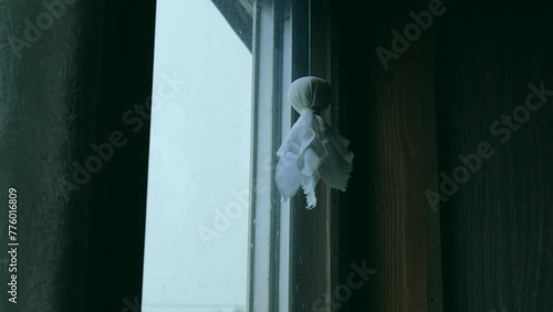 雨の日　窓辺に吊るされたテルテル坊主　日本の風習 photo
