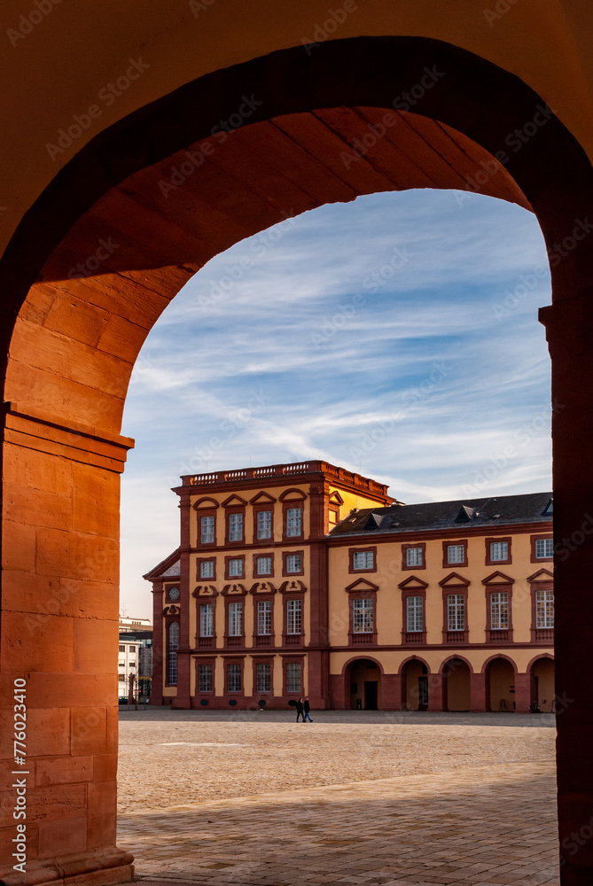 Fototapeta premium Beautiful view of the Mannheim Baroque Palace through the arch on a sunny day in Germany