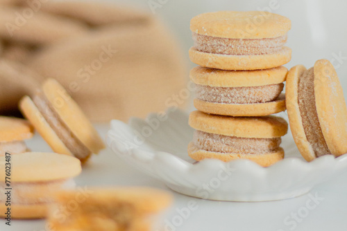 Tableau sur toile Beige biscuits on white background. Minimalist composition.