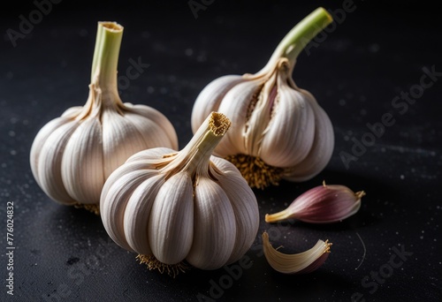 Organic garlic bulbs and black background