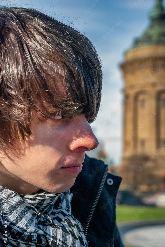 Man near the old water tower of Mannheim in Germany Man near the old water tower of Mannheim in Germany
