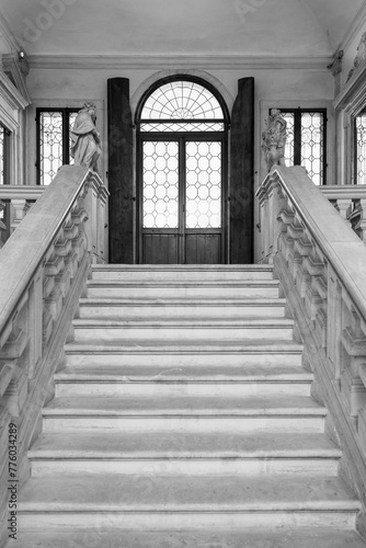 Black and white photo of stairs inside historic palace in the italian city of Padova