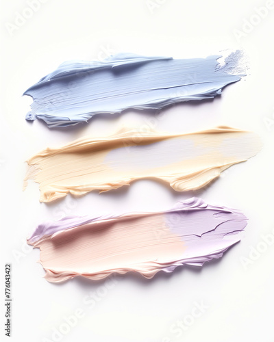 Samples of oval cream corrector in yellow, blue, lilac, pink for the face on a light background