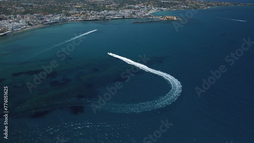 Aerial view by drone of idyllic seascape with jet boat on Crete, Greece. photo