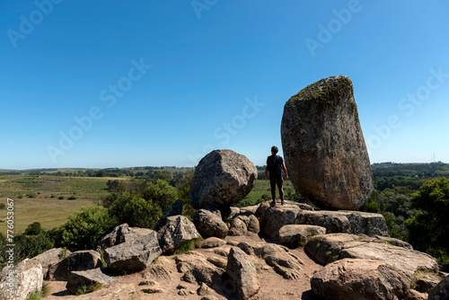young traveling man in the mountains enjoying the great landscape between rocks and free vegetation observing 