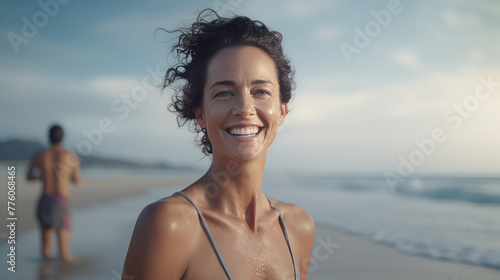 Happy woman in the fourties at beach photo