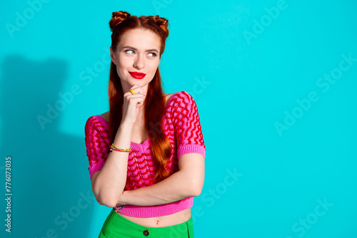 Photo of pretty thoughtful lady dressed pink knitted shirt arm chin looking empty space isolated blue color background © deagreez