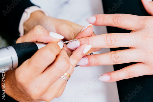 Close up picture of beautician fixing cuticle
