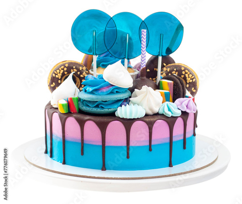 Birthday blue and purple cake on neutral background with lollipops and donuts