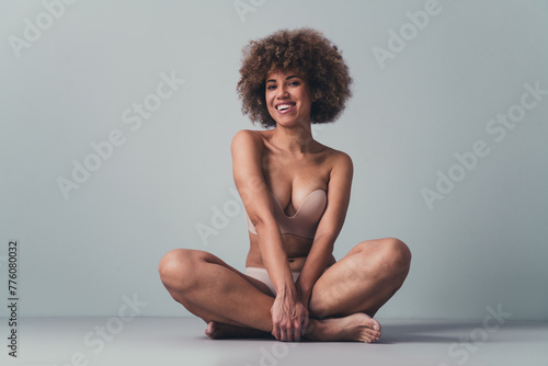 Unretouched photo of laughing girl sitting in lingerie feel joyful self love natural body isolated grey color background © deagreez