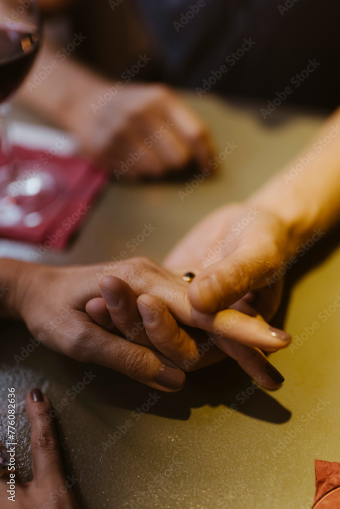 High angle view of mature couple holding hands at restaurant High angle view of mature couple holding hands at restaurant