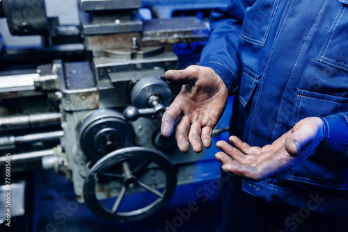 Working men with dirty hands stay near milling machine. Concept hard work of industry © Parilov