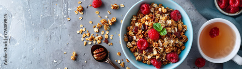 Elegant panoramic view of a gourmet granola meal with fresh berries, nuts, and a side of tea on a textured backdrop. photo