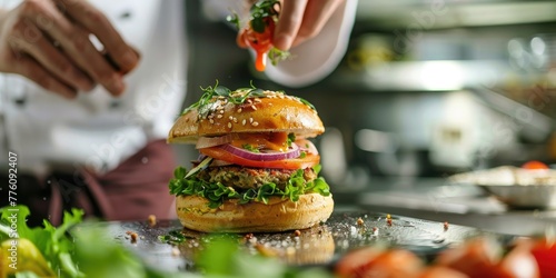 A chef expertly finalizes a vegan burger with fresh toppings in a professional kitchen, showcasing culinary art and healthy cuisine. photo