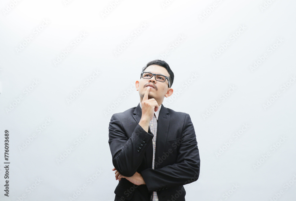 Waist-up portrait of thoughtful, creative and smart asian young man in black suit, office manager, businessman planning project, thinking looking up pondering ideas, white background Waist-up portrait of thoughtful, creative and smart asian young man in black suit, office manager, businessman planning project, thinking looking up pondering ideas, white background