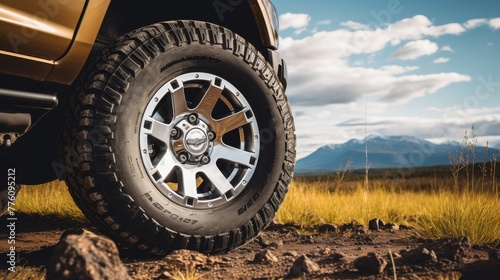 Off road tire with alu rim on Landscape background