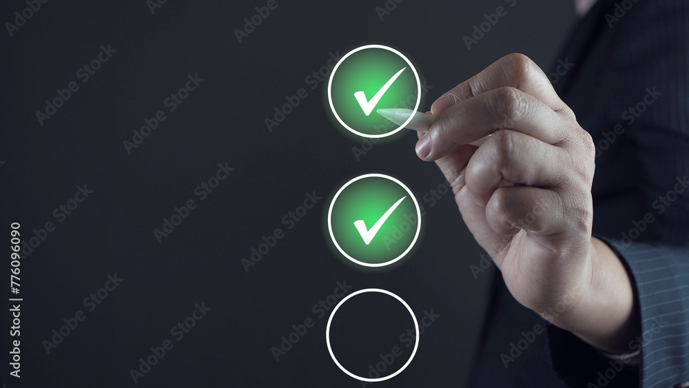 Businessman using pen to tick correct sign mark in checkbox for quality document control checklist and business approve project concept. Businessman using pen to tick correct sign mark in checkbox for quality document control checklist and business approve project concept.