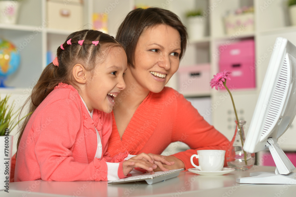 Close up porait of mother and daughter using laptop Close up porait of mother and daughter using laptop