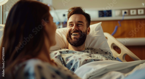 Happy man in hospital bed talking to a woman, smiling and looking at her with love