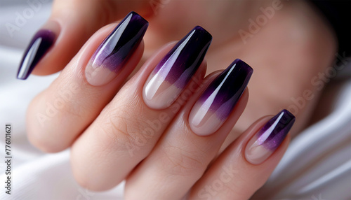Gel nail extension dark purple. A long nail extension with a lilac coating of nail polish. close up