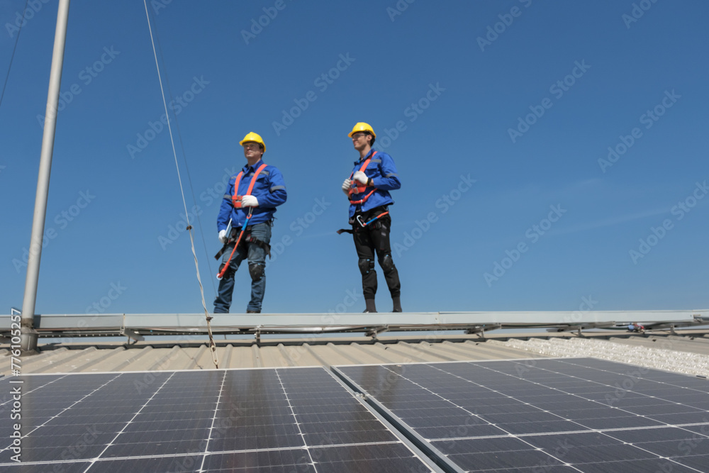 Engineers or workers install and inspect solar cell on the roof of the factory. Engineers or workers install and inspect solar cell on the roof of the factory.