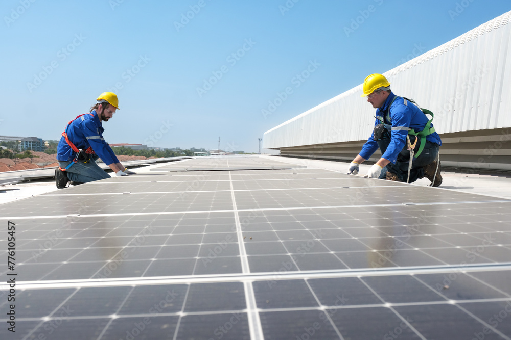 Engineers or workers install and inspect solar cell on the roof of the factory. Engineers or workers install and inspect solar cell on the roof of the factory.