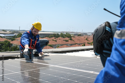 Engineers or workers install and inspect solar cell on the roof of the factory.