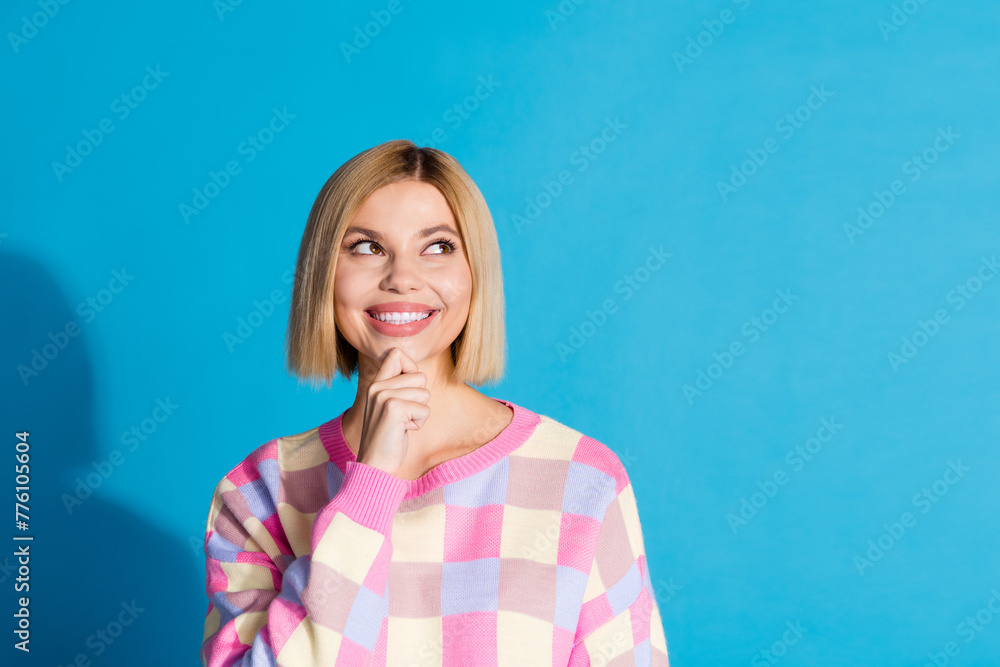 Portrait of minded girl with bob hair wear checkered pullover thoughtfully look at offer empty space isolated on blue color background Portrait of minded girl with bob hair wear checkered pullover thoughtfully look at offer empty space isolated on blue color background