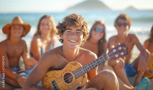 Handsome teenager boy playing Ukulele instrument on the seaside sandy ocean beach while spending funny time with friends. Active People, friends relations and summer vacation concept. #776107439
