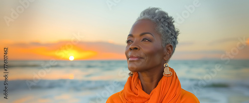 Beautiful senior African woman portrait standing on the beach on the sunset, sea on the background. Summer vacation concept. #776107462