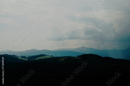 Beautiful green mountains with cloudy sky background. Summer vacation. Mountain landscape.