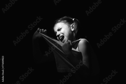 Lost childhood, emotional pain, and children's pain, depression and domestic violence concept. Portrait of sad and desperate young girl crying.