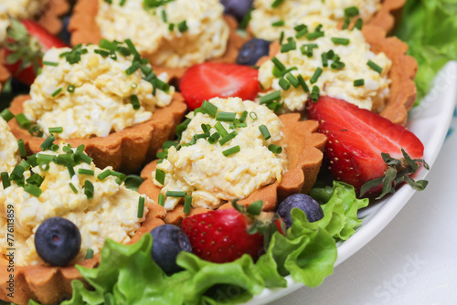 Egg paste cupcake. Egg spread tartlets. Boiles eggs with mayo on baked tarta cake sprinkled with chives onion spring. Salty party snack. Eggs salad on tartlet. Easter modern style food. photo