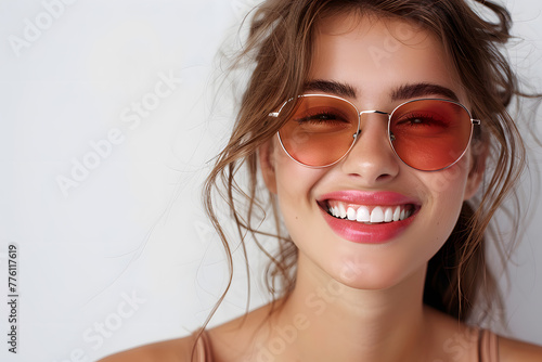 Closeup portrait of a beautiful woman wearing sunglasses happy and smiling