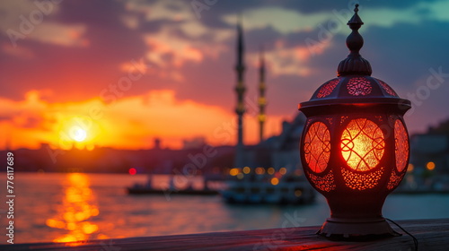 Elegant lantern casting a warm glow on a waterfront promenade with the iconic silhouette of a mosque against the dusk sky in the background