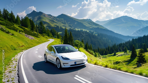 A modern electric car drives along a beautiful winding road surrounded by forests and mountains. Eco-friendly transport