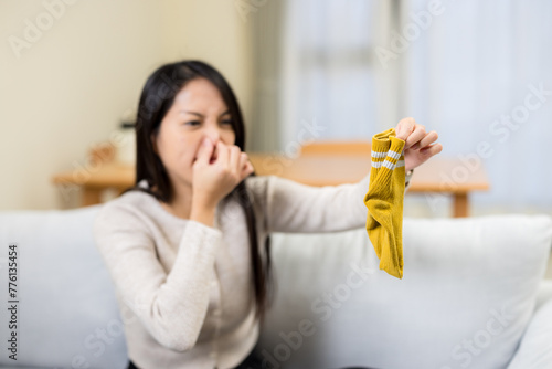 Woman hold with smells stinky sock