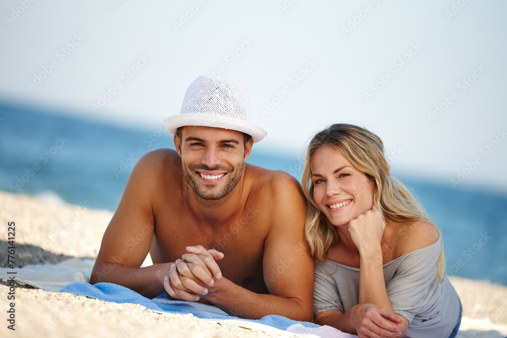 Couple, portrait and relax on sand or vacation, smile and peace at beach or lying by water. People, happy and tropical ocean for bonding on weekend, outdoor nature and love for marriage or romance