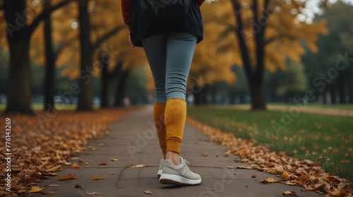 Back view of close-up of a woman's leg walking in autumn park,she have sports cloths, instagram style.generative.ai