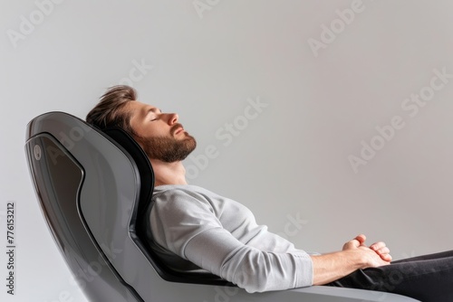 Man relaxes in a massage chair Isolated on white background