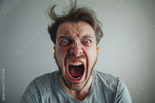 man is yelling with a fully open mouth photo