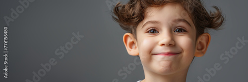Cute young child with prominent protruding ears on a light background. Most commonly treated auricular deformity. Setback otoplasty banner. © MNStudio