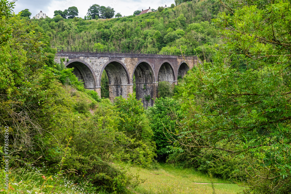 Monsal Head and Monsal Dale and the old railway viaduct over the river Wye in the Peak District in Derbyshire, England